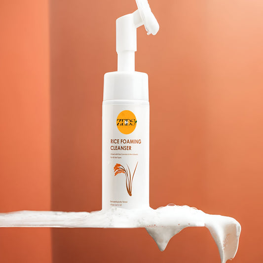 White bottle of ZO Skin Health Rice Foaming Cleanser with foam on an orange background