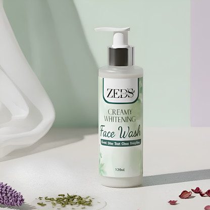ZEDS Creamy Whitening Face Wash bottle on a white surface with decorative elements.