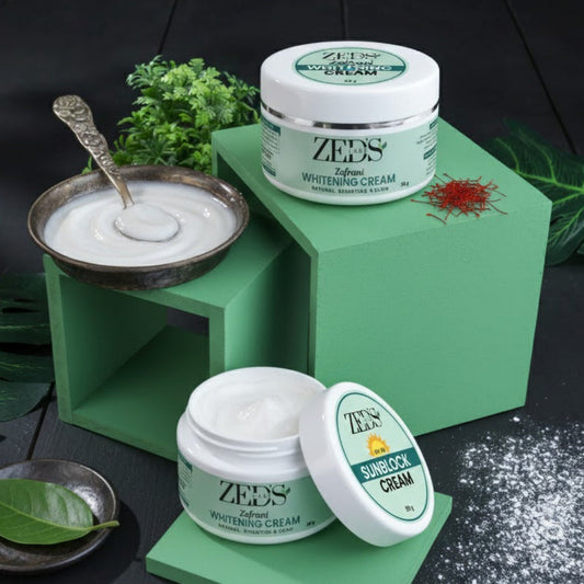 Two jars of ZEDS CARE sunscreen cream on green stands with a black background